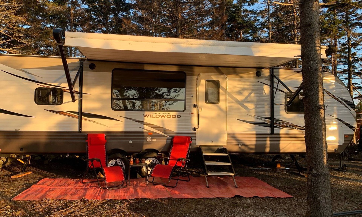 Clare House | Modern RV camper with all the perks Nestled in tree at lake edge