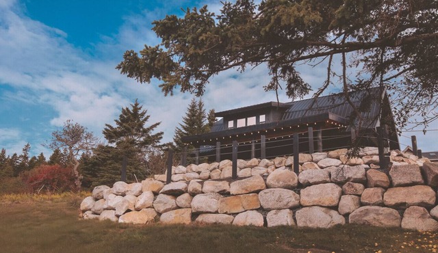 A reconstructed German LogHaus and sanctuary of unmediated coastal observation.
