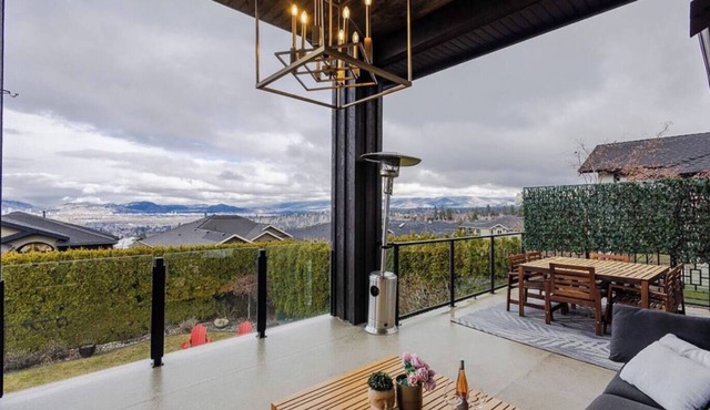 Bright open-concept home in Kelowna with lake views, high ceilings, fireplace.