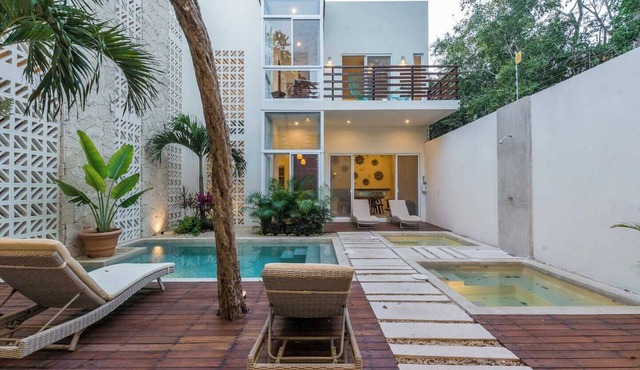 Experience tropical luxury in our villa with pools, lush surroundings, and concierge in Aldea Zama