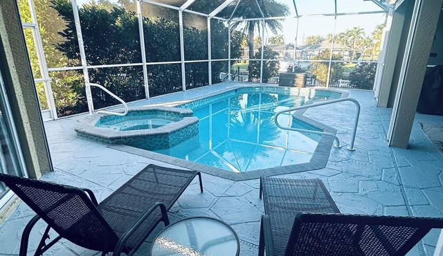 Spacious 4 bed 3 bath heated pool home with hot tub in prime Cape Coral location